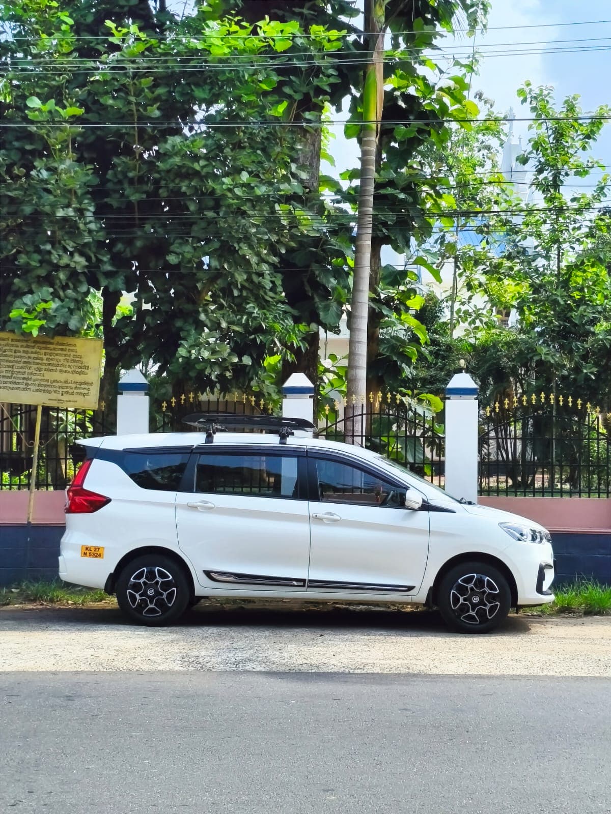 Maruti Suzuki Ertiga — clean side profile parked on a Kerala roadside